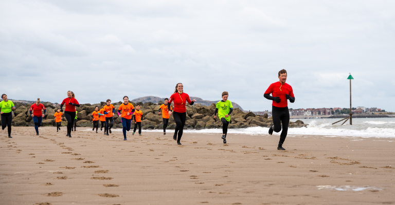 People running on the beach