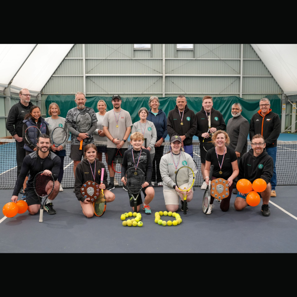 Picture of tennis player at tennis centre with 20 written in tennis balls