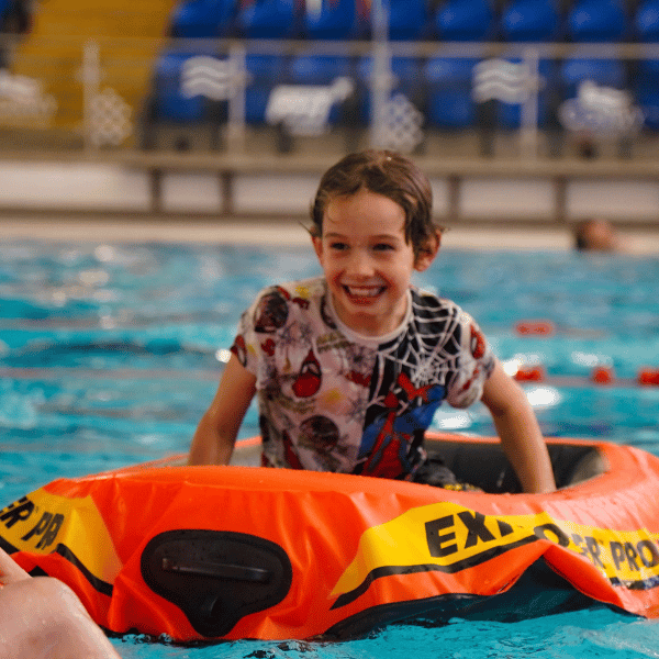 Picture of boy on boat in a swimming pool