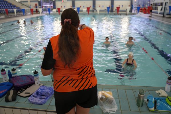instructor leading swimming class