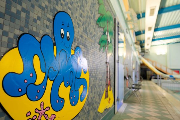 Cartoon signage at side of swimming pool.