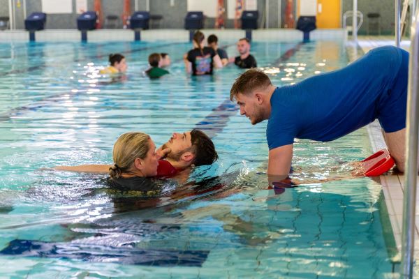 Staff and customers engaged in lifeguard training.